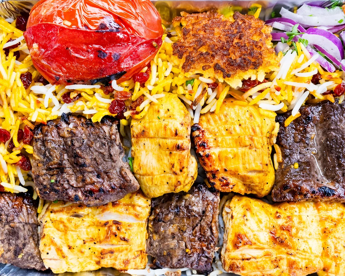 Bakhtiari: alternating grilled steak and saffron chicken pieces on saffron rice with barberries and a grilled tomato at AFRA Grill, Saskatoon